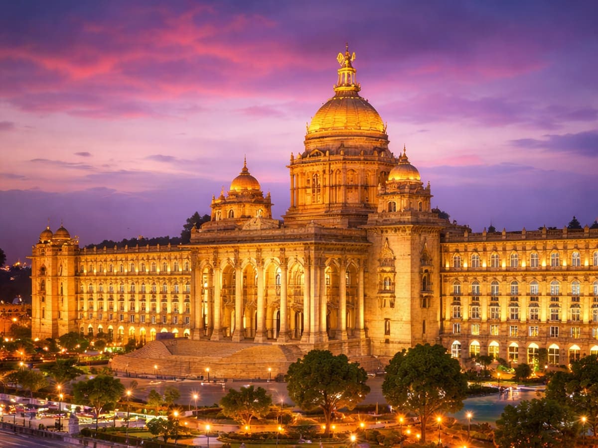 Vidhana Soudha in Bangalore lit at dusk under a violet sky